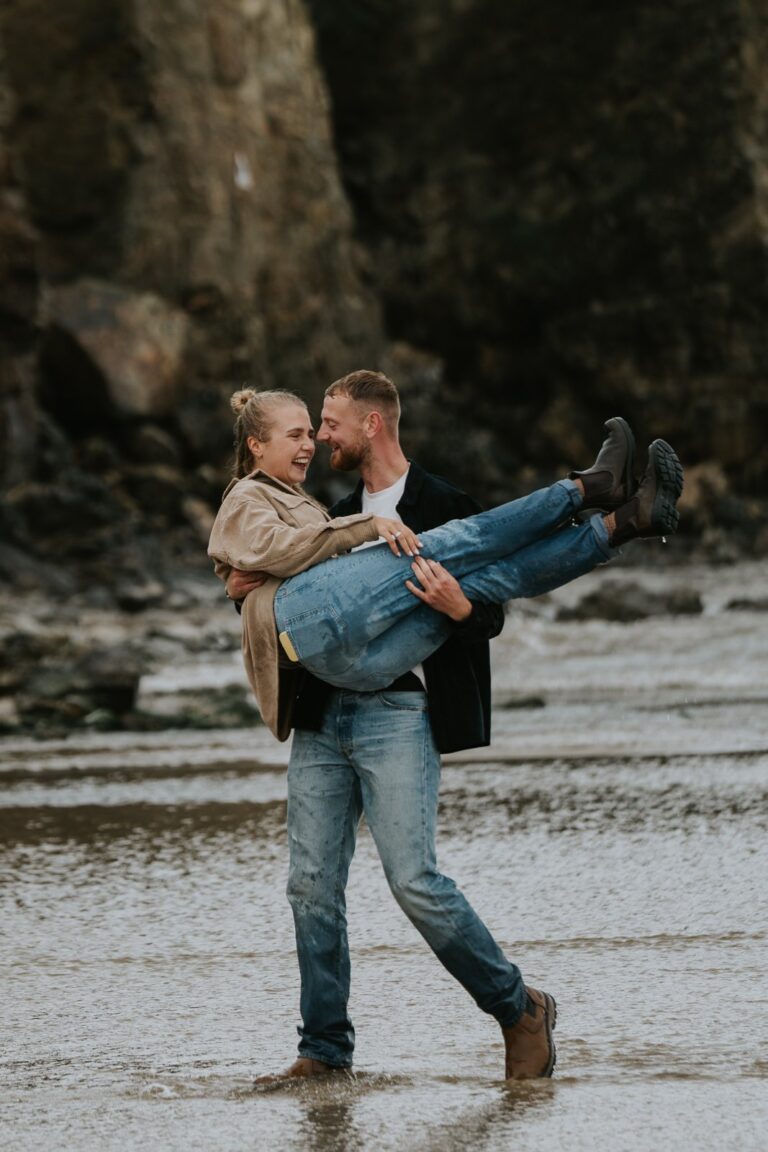 couple in embrace in rainy photoshoot in cornwall