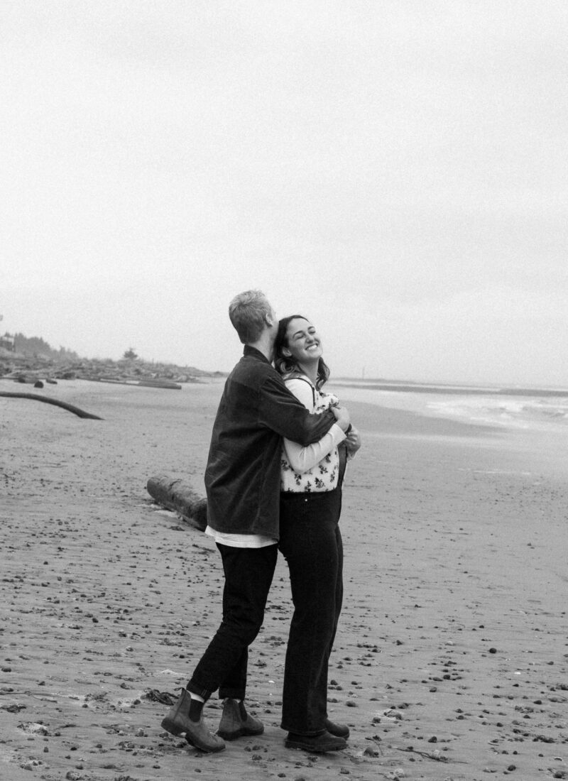 Couple in embrace on Saratoga beach on Vancouver Island.