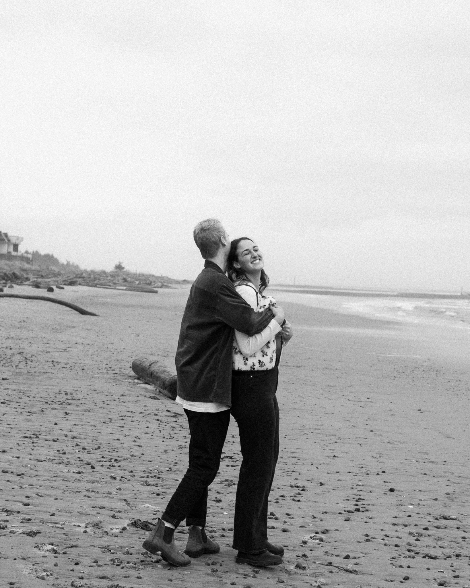 Couple in embrace on Saratoga beach on Vancouver Island.
