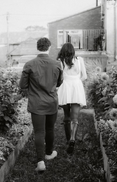 couple running through rows of flower farm