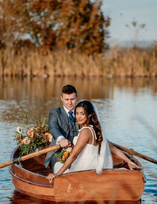 Bride and groom on a boat as part of their intimate wedding