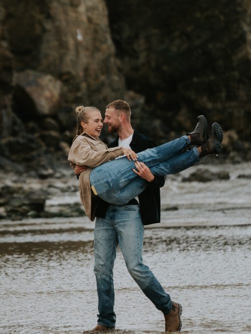 couple in embrace in rainy photoshoot in cornwall